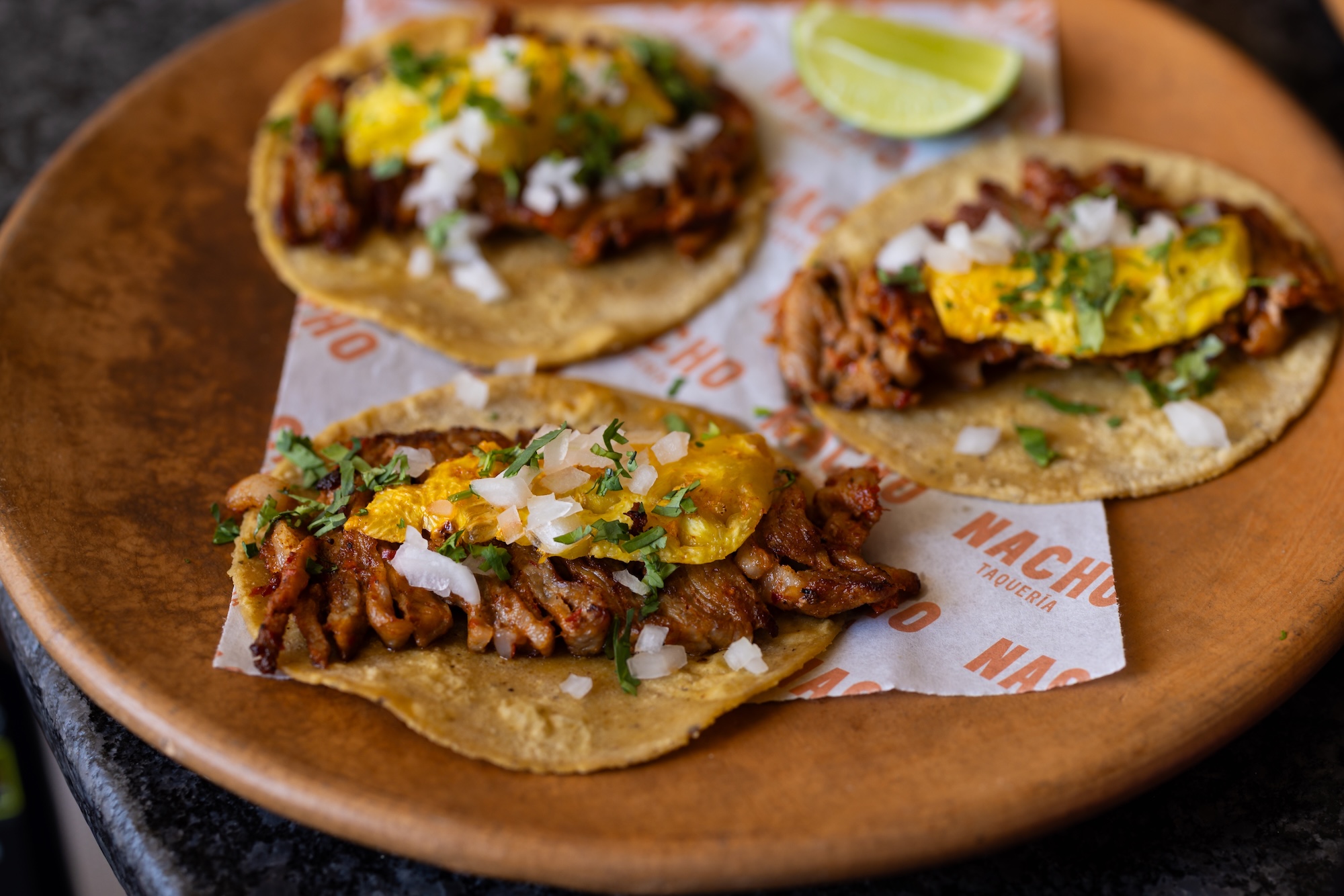 Tacos al pastor with charred pineapple at Nacho